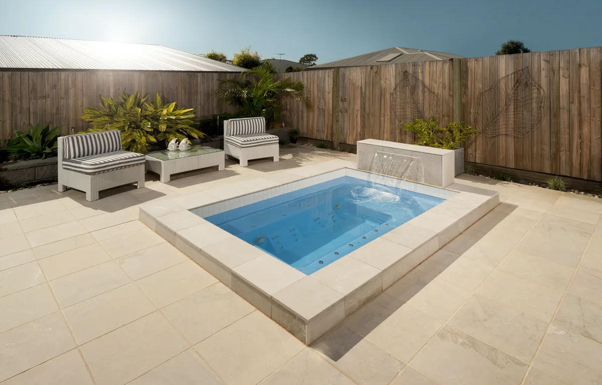 A completed fibreglass pool in a Redbank Plains, QLD backyard showing finish and landscaping