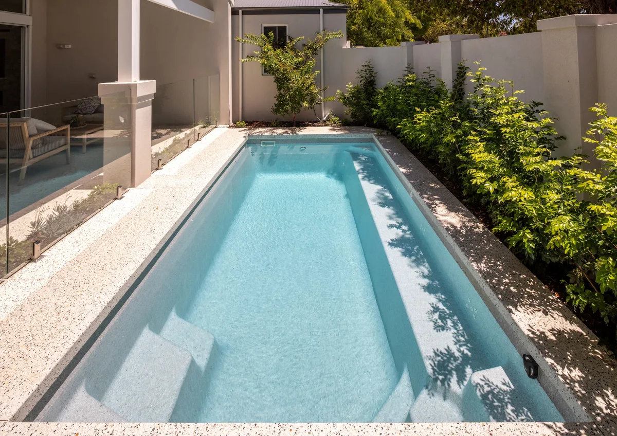 A completed fibreglass pool in a Greenbank, QLD backyard showing finish and landscaping