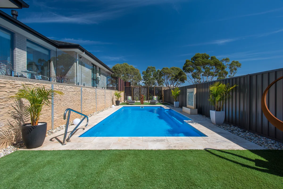 A completed fibreglass pool in a Loganlea, QLD backyard showing finish and landscaping