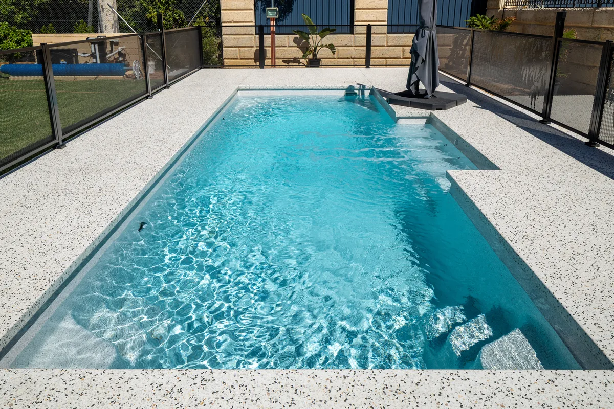 A completed fibreglass pool in a South Brisbane, QLD backyard showing finish and landscaping